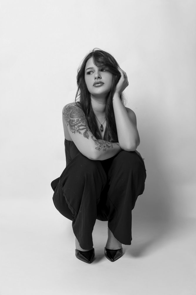 Fine art, styled model portrait highlighting fashion elements and soft shadows